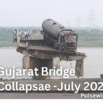 A large tanker truck precariously stuck on a section of a collapsed bridge over a river, with people standing on the intact part and debris visible in the water. The text "Gujarat Bridge Collapse - July 2025" is overlaid.