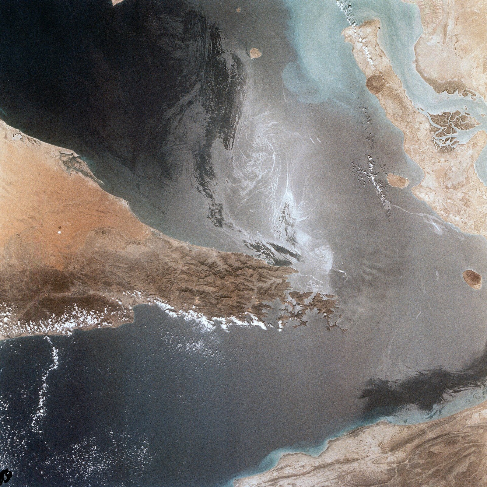 US jet disables cargo ship trying to run Iran blockade in Gulf of Oman as IRGC says it hit LPG carrier near Hormuz